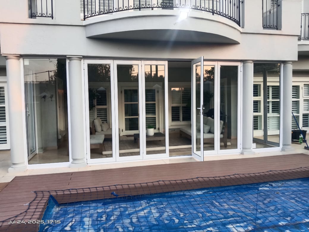 Multi-panel aluminium folding door installation — Sandton, Gauteng by Trideniel Aluminium & Glass