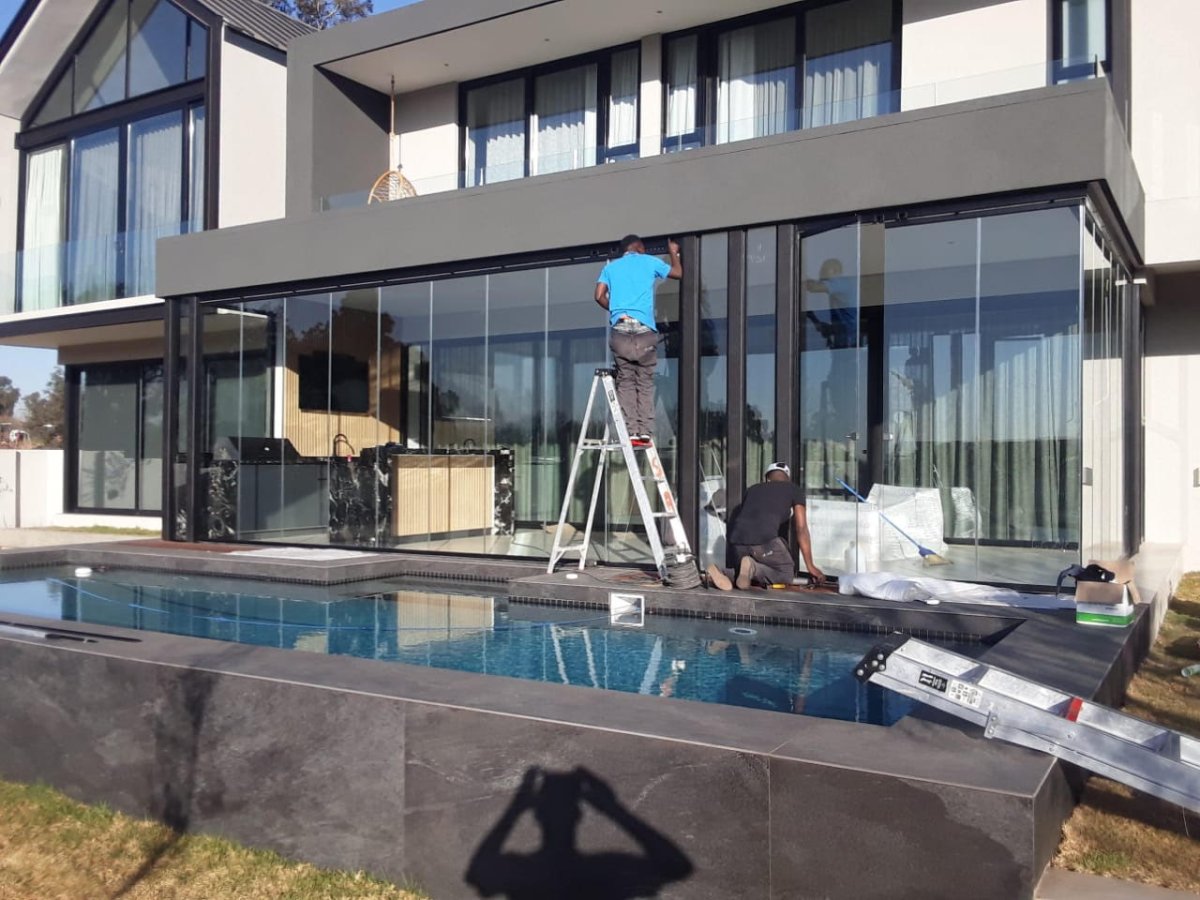 Frameless folding door repair — Sandton Gauteng by We Fix Doors Trideniel Aluminium & Glass